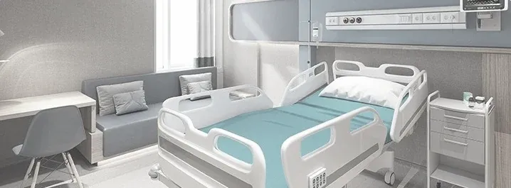 A hospital ward room with a patient bed