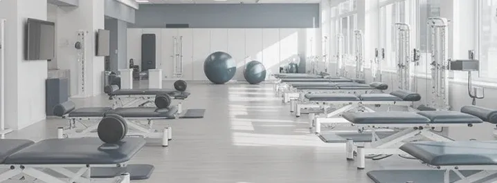 A bright outpatient rehabilitation gym with treatment tables