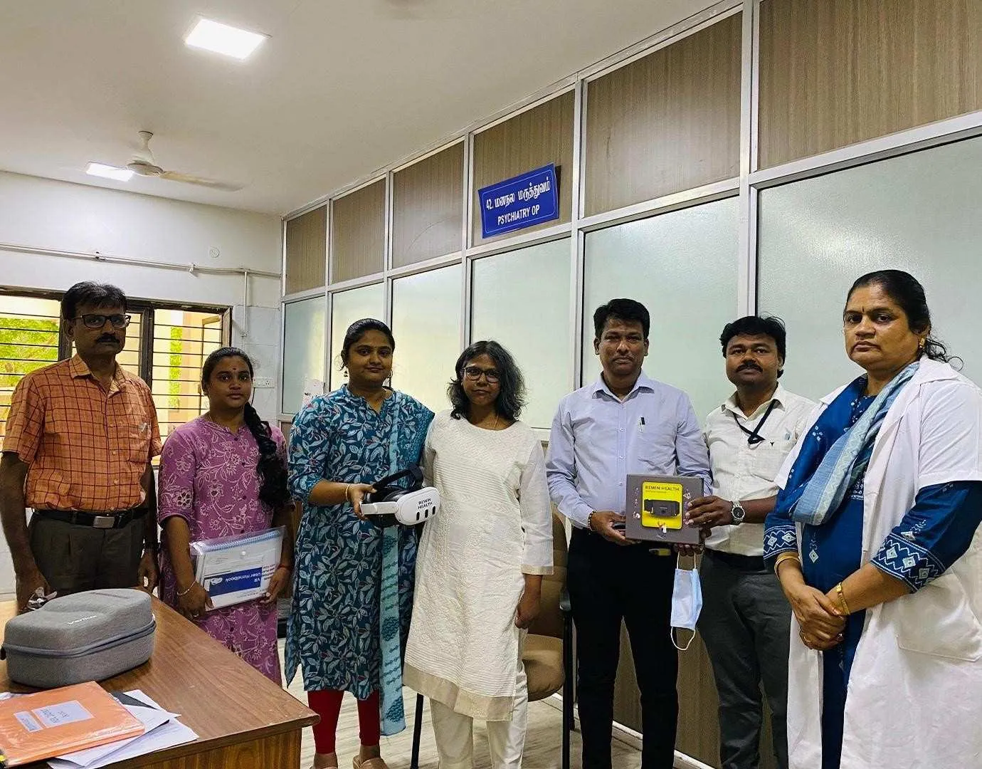 A Rewin VR headset and motion sensor handed over to a hospital department team
